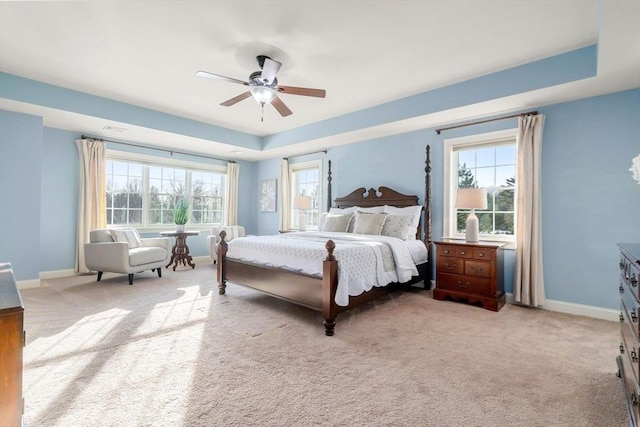 bedroom featuring multiple windows, baseboards, and carpet flooring