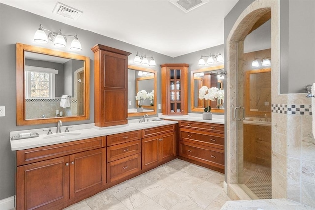 full bath featuring a stall shower, visible vents, and a sink