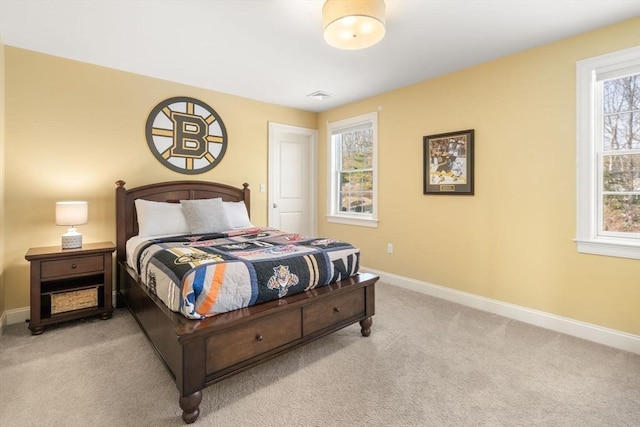 bedroom with light carpet and baseboards