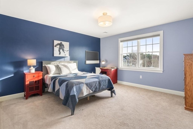 bedroom with carpet floors and baseboards