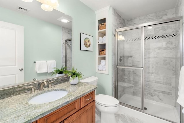 full bath with marble finish floor, visible vents, toilet, a shower stall, and vanity