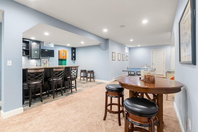 dining space with light carpet, recessed lighting, baseboards, and wet bar