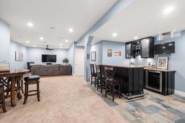 bar with recessed lighting, ceiling fan, wet bar, beverage cooler, and baseboards