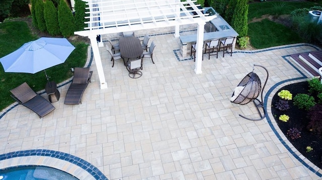 view of patio featuring outdoor dining area, outdoor dry bar, and a pergola