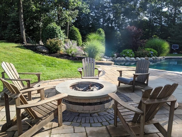 view of patio with an outdoor fire pit and an outdoor pool