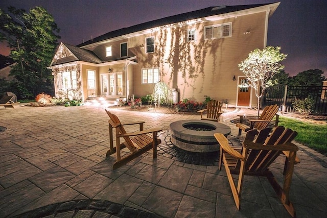 view of patio / terrace featuring french doors, an outdoor fire pit, and fence