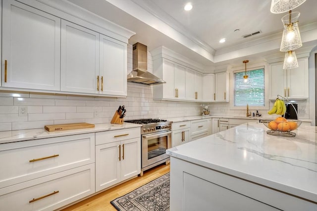 11 Conway St Unit 3, Boston, MA 02131 - kitchen featuring wall chimney exhaust hood, high end range, white cabinetry, crown molding, and recessed lighting