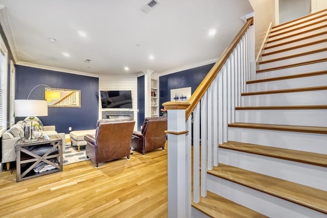 11 Conway St Unit 3, Boston, MA 02131 - stairs with wood finished floors, ornamental molding, decorative columns, a fireplace, and recessed lighting