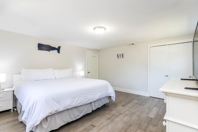 bedroom with a closet and light hardwood / wood-style floors