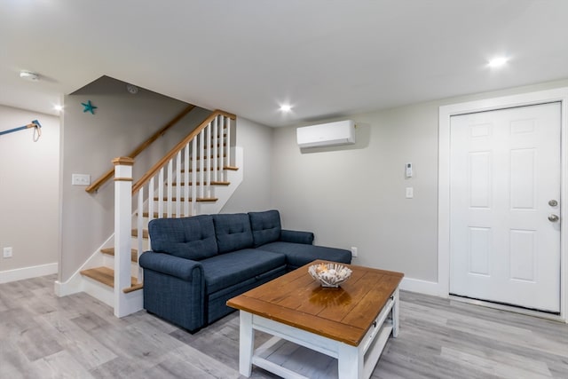 living room featuring a wall mounted AC and light wood-type flooring