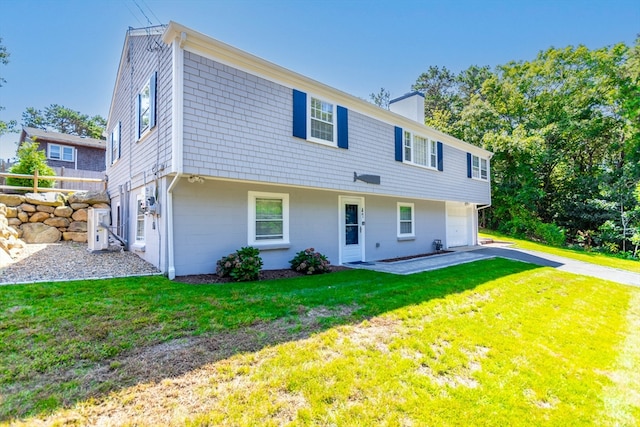 view of front of house featuring a front lawn and a patio