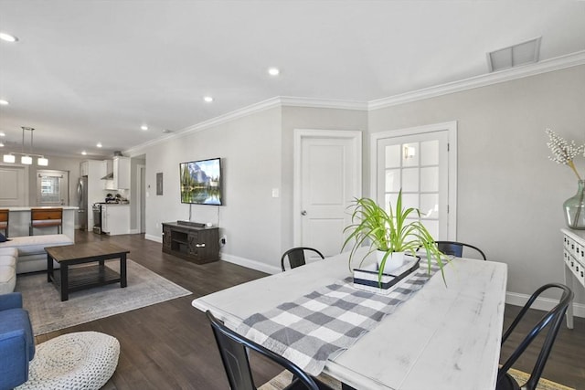 dining room featuring crown molding and dark hardwood / wood-style floors