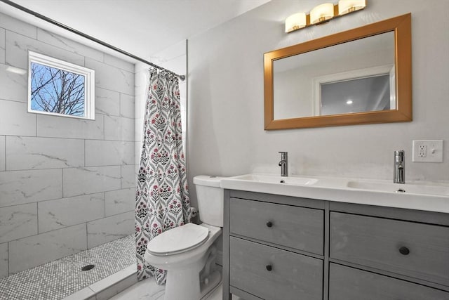 bathroom featuring toilet, vanity, and a shower with curtain