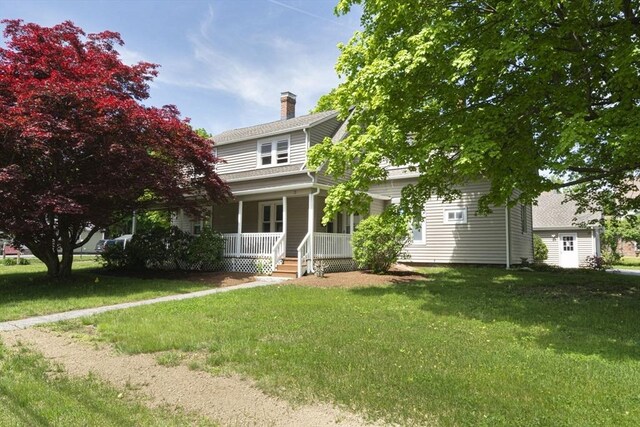 view of front of home with covered porch and a front yard