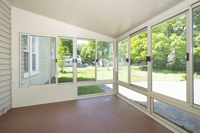 unfurnished sunroom featuring lofted ceiling