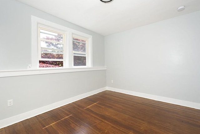 unfurnished room with hardwood / wood-style flooring