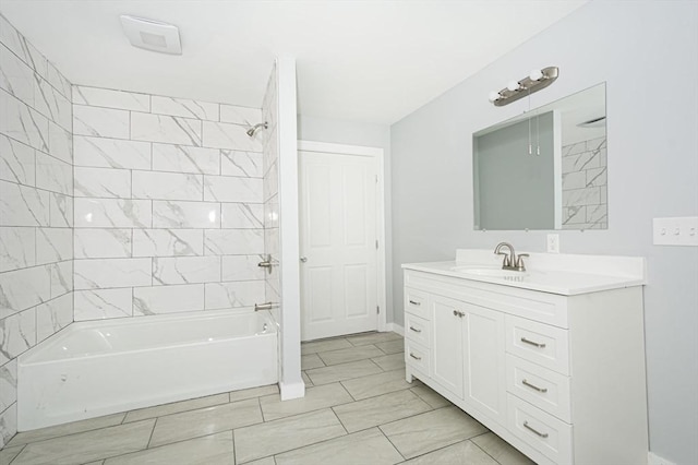 bathroom with vanity and tiled shower / bath combo