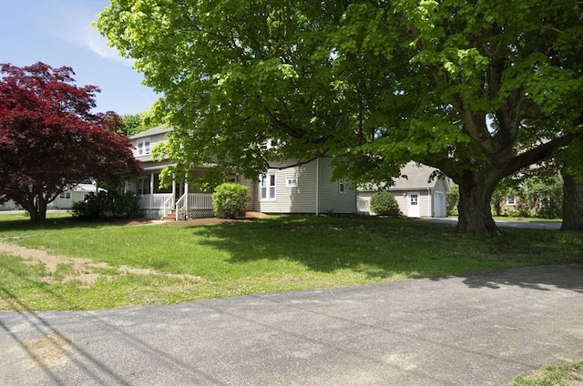 exterior space featuring a porch and a front yard