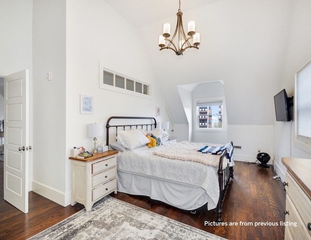 bedroom featuring dark hardwood / wood-style floors, a chandelier, and vaulted ceiling