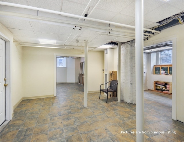 basement featuring a paneled ceiling