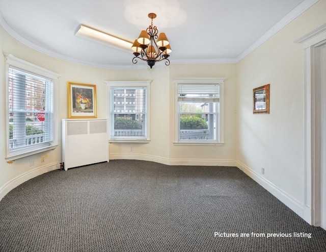 carpeted empty room with a notable chandelier, a healthy amount of sunlight, ornamental molding, and radiator