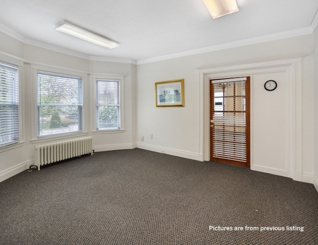 carpeted spare room with radiator heating unit and ornamental molding