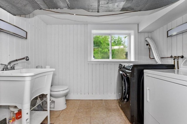 6 Cherry Ridge Rd, Acton, MA 01720 - laundry area with washer and clothes dryer, light tile patterned flooring, and wooden walls