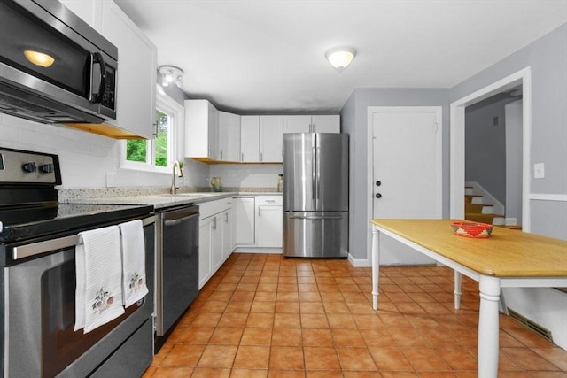6 Cherry Ridge Rd, Acton, MA 01720 - kitchen with appliances with stainless steel finishes, light countertops, white cabinets, tasteful backsplash, and light tile patterned floors