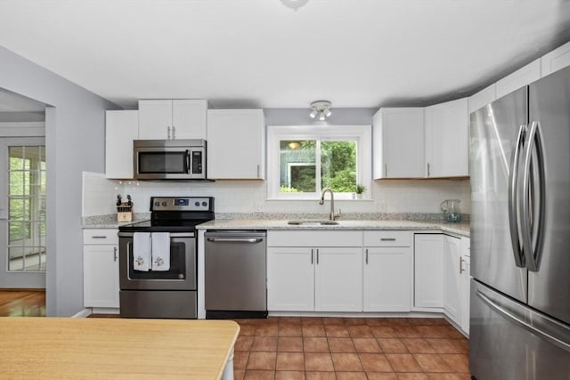 6 Cherry Ridge Rd, Acton, MA 01720 - kitchen with stainless steel appliances, decorative backsplash, and white cabinets