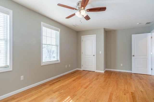 unfurnished bedroom with ceiling fan and light wood-type flooring