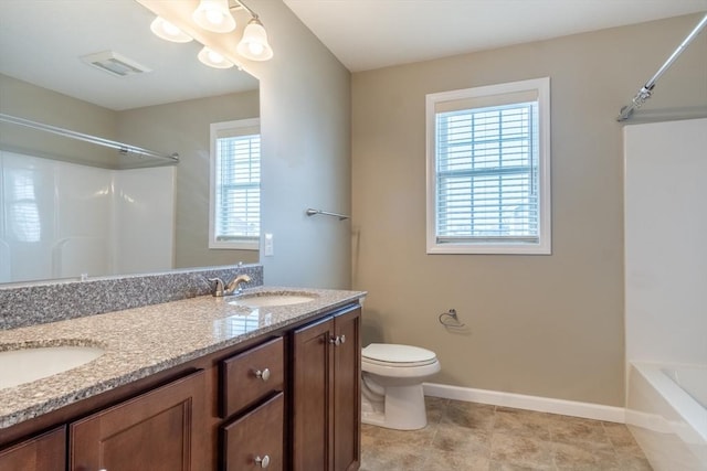 bathroom with vanity, toilet, and plenty of natural light