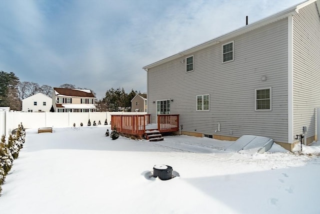 snow covered property featuring a wooden deck