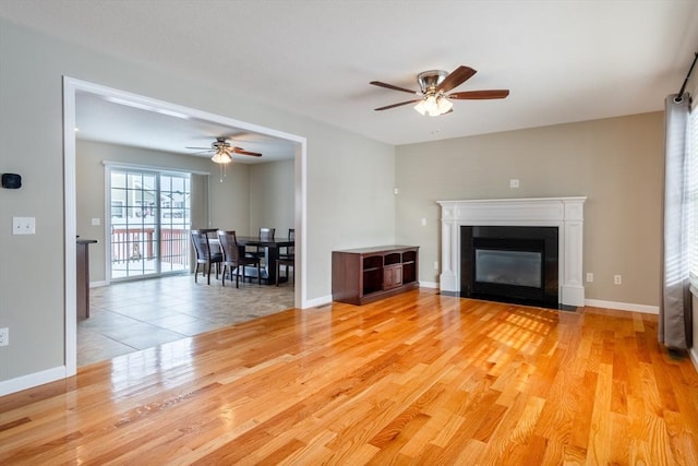 unfurnished living room with light hardwood / wood-style flooring and ceiling fan