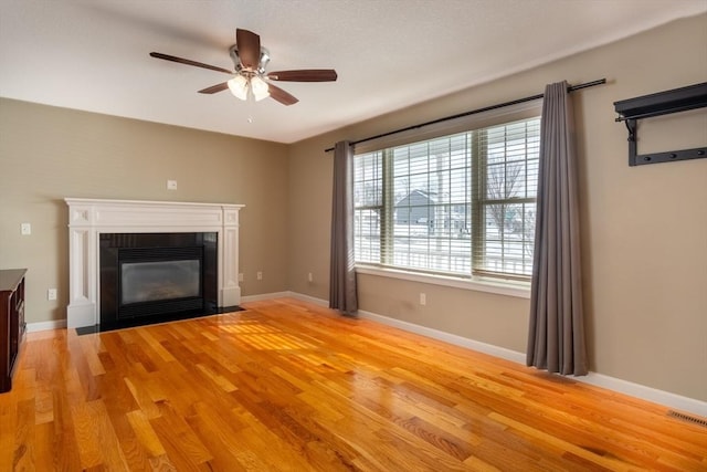 unfurnished living room with ceiling fan and light hardwood / wood-style floors