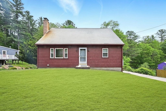 77 Marblehead St, North Reading, MA 01864 - view of front of home featuring a chimney, a front yard, and roof with shingles