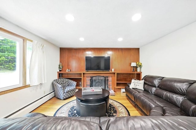 77 Marblehead St, North Reading, MA 01864 - living area featuring a baseboard heating unit, recessed lighting, wood finished floors, wooden walls, and a fireplace