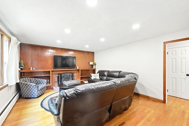 77 Marblehead St, North Reading, MA 01864 - living room featuring a baseboard heating unit, light wood-style floors, recessed lighting, baseboards, and wood walls
