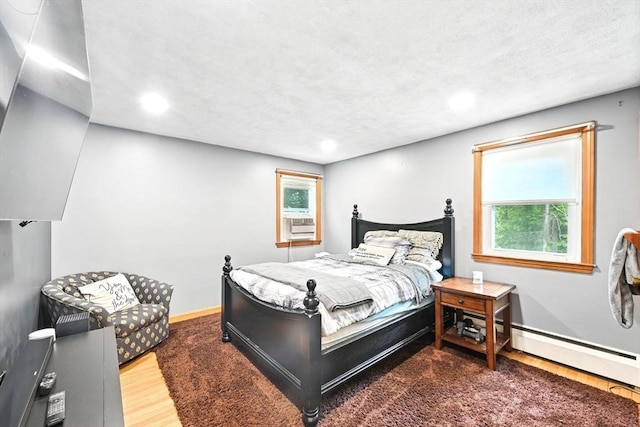 77 Marblehead St, North Reading, MA 01864 - bedroom featuring wood finished floors, recessed lighting, baseboards, cooling unit, and a baseboard radiator