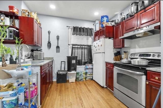 629 Cambridge St, Worcester, MA 01610 - kitchen with under cabinet range hood, stainless steel range with electric cooktop, dark brown cabinets, a sink, and recessed lighting