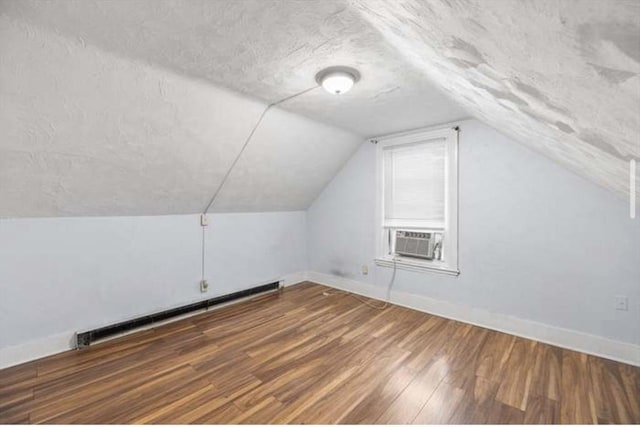 629 Cambridge St, Worcester, MA 01610 - bonus room with baseboard heating, cooling unit, wood finished floors, baseboards, and vaulted ceiling