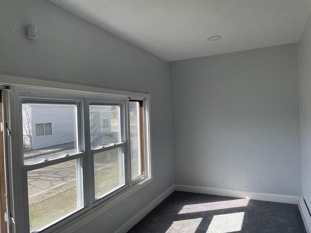 629 Cambridge St, Worcester, MA 01610 - spare room with baseboards, dark colored carpet, and a baseboard heating unit