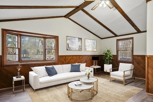 living room featuring wood-type flooring, wooden walls, and lofted ceiling with beams