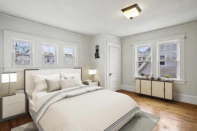 bedroom featuring multiple windows and hardwood / wood-style floors