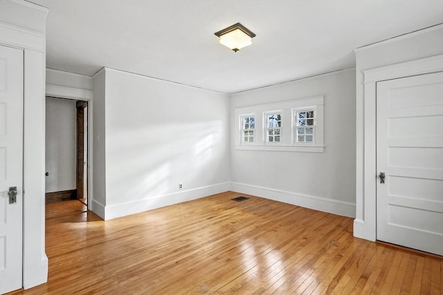 unfurnished room with light hardwood / wood-style floors