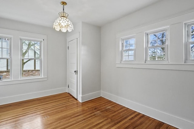 unfurnished room with hardwood / wood-style flooring