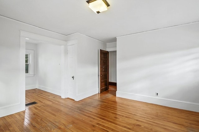 spare room featuring wood-type flooring