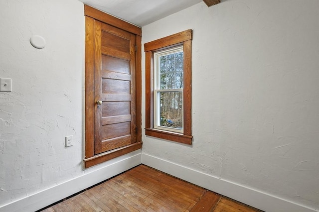 empty room with hardwood / wood-style flooring