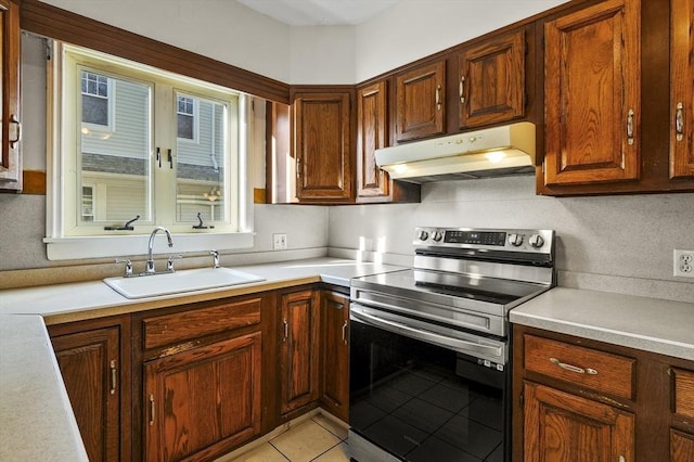 kitchen with sink, stainless steel range with electric cooktop, and light tile patterned floors