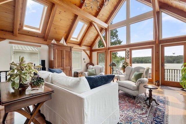 living room featuring a skylight, high vaulted ceiling, a water view, wood ceiling, and beam ceiling