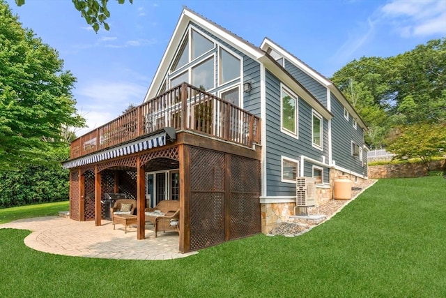 rear view of property with a wooden deck, a yard, a patio, and cooling unit